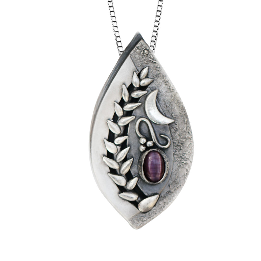 One of a kind, fine silver pendant with no detail overlooked. This elegant pendant will sure to be cherished and loved for years to come. Handmade by a local Edmonton Artist, this pendant is truly special with its nature-inspired whimsical winding vines and moon accent. Metal: Fine 99.9% Silver Pendant Stone Type: Dyed Syn. Sapphire Stone Cut: Oval Chain: Adjustable to 22″ Sterling Silver