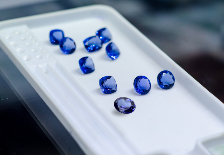 What are the key differences between blue sapphire and tanzanite?