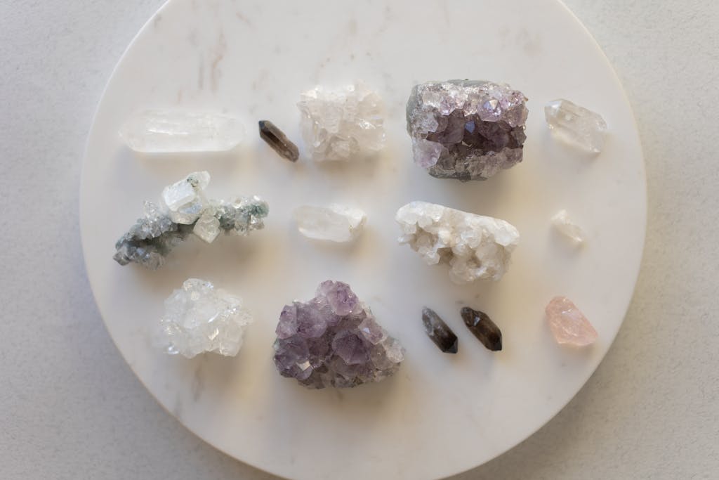 A top view of various healing crystals on a marble surface, showcasing natural beauty.