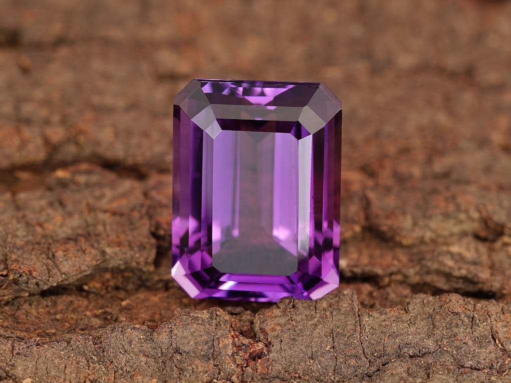 Close-up of a beautiful amethyst gemstone showcasing its vibrant purple hue and precision cut.